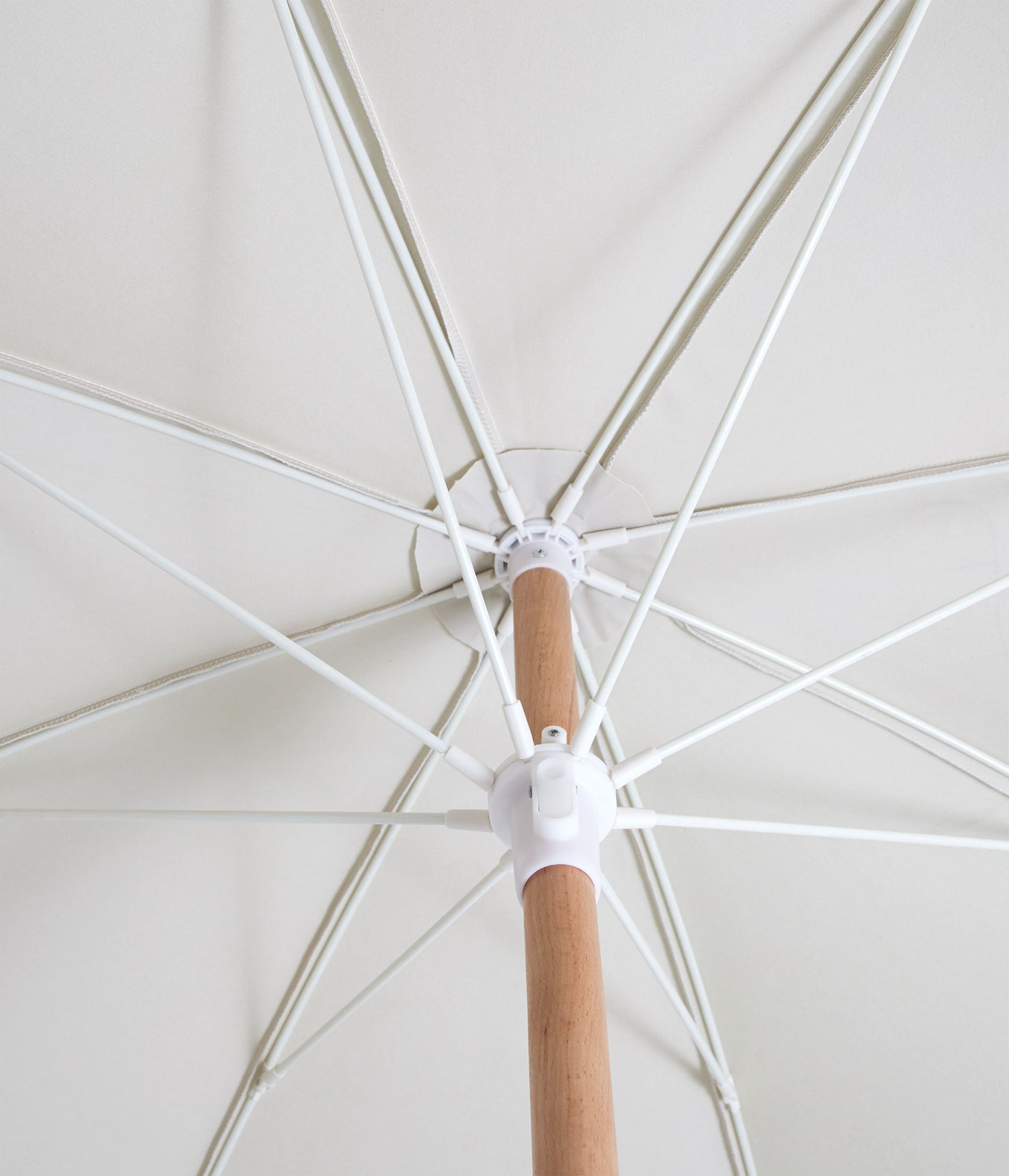 Sunday Supply Co Salt beach umbrella open and seen from underneath.