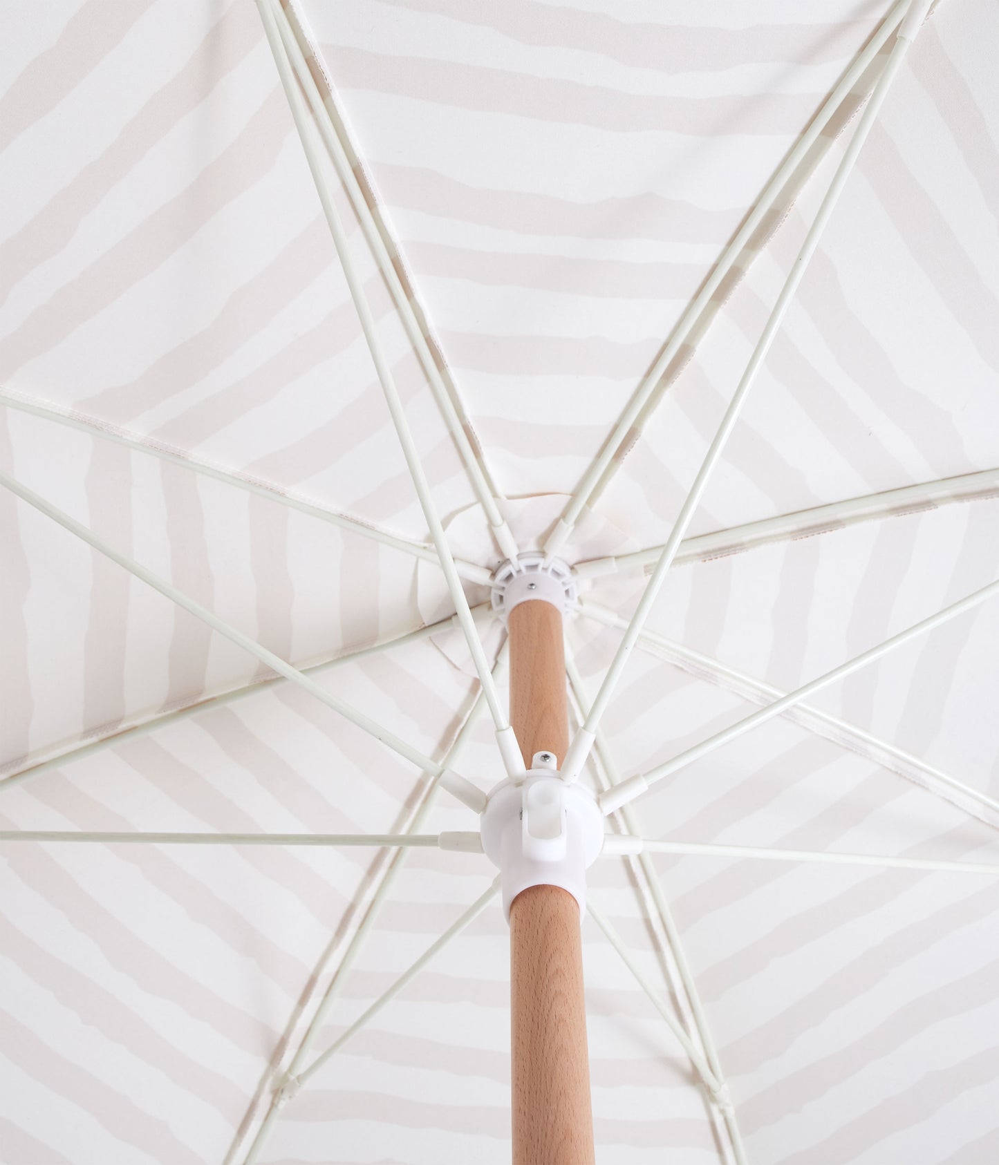 Sunday Supply Co Sun Ray beach umbrella open and seen from underneath.